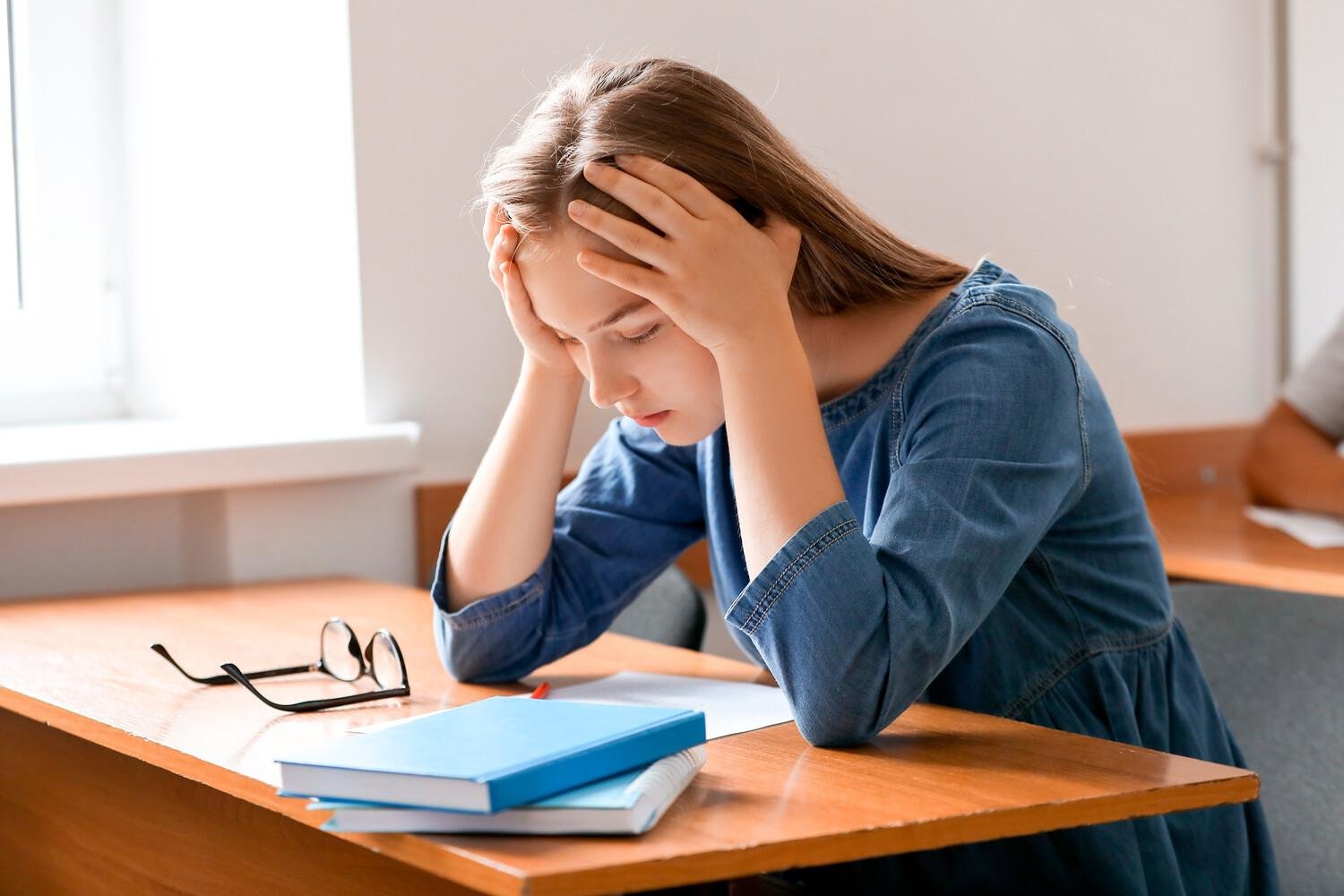 Student experiencing exam stress while preparing for the SAT.