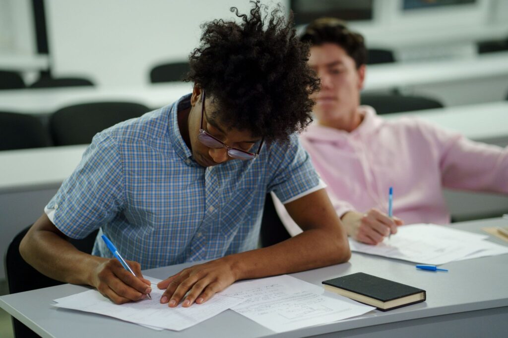 High school student preparing for AP Exams with study notes and practice tests