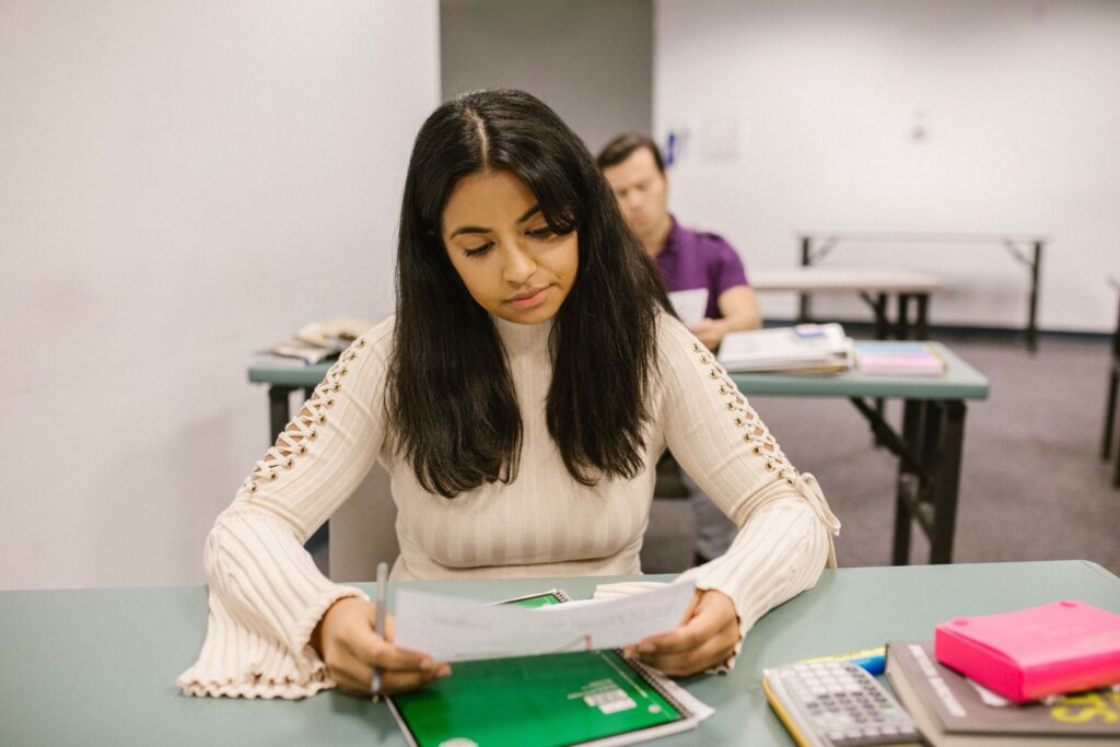 Student taking a standardized college entrance exam, working through questions on paper.